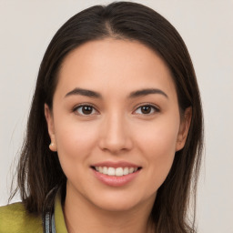 Joyful white young-adult female with long  brown hair and brown eyes