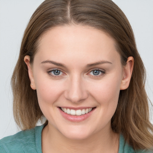 Joyful white young-adult female with long  brown hair and grey eyes