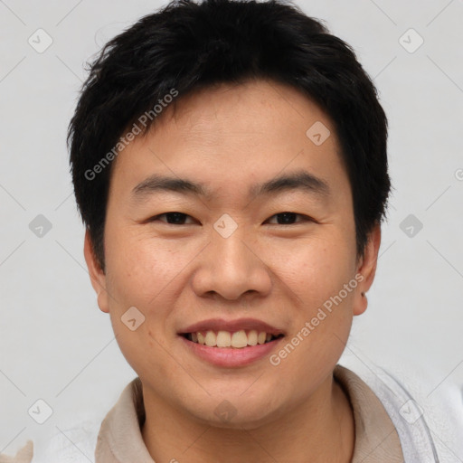 Joyful asian young-adult male with short  black hair and brown eyes