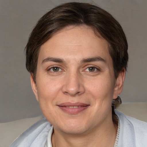 Joyful white adult female with short  brown hair and brown eyes