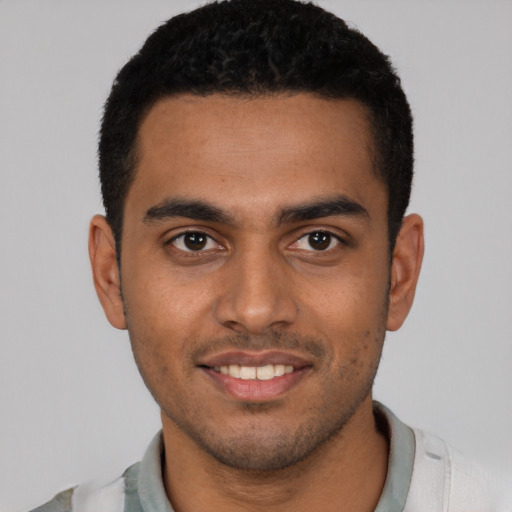 Joyful latino young-adult male with short  brown hair and brown eyes