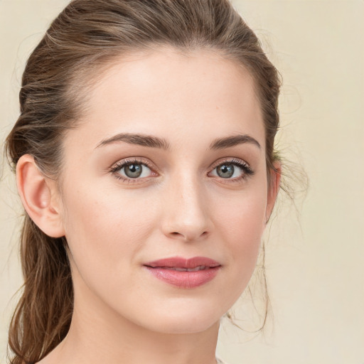 Joyful white young-adult female with medium  brown hair and green eyes