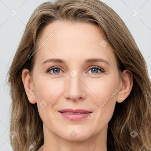 Joyful white adult female with long  brown hair and grey eyes