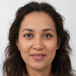 Joyful white adult female with long  brown hair and brown eyes