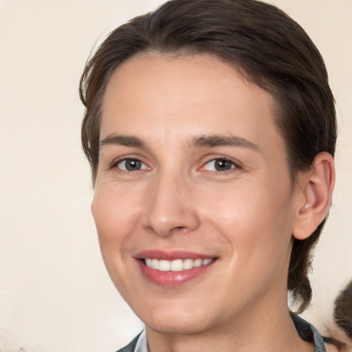 Joyful white young-adult female with medium  brown hair and brown eyes