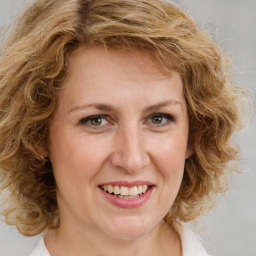 Joyful white young-adult female with medium  brown hair and green eyes