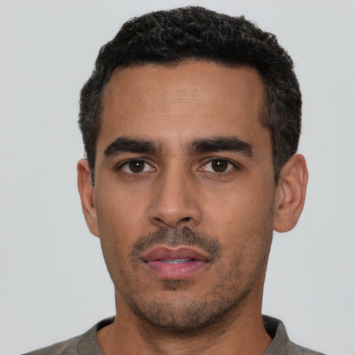 Neutral latino young-adult male with short  black hair and brown eyes