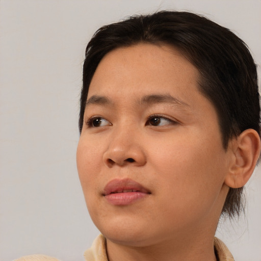 Joyful asian young-adult female with short  brown hair and brown eyes