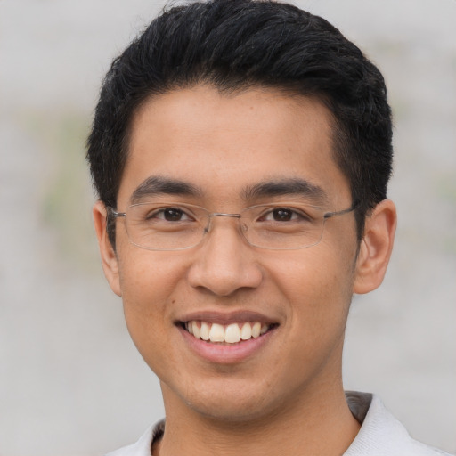 Joyful asian young-adult male with short  brown hair and brown eyes