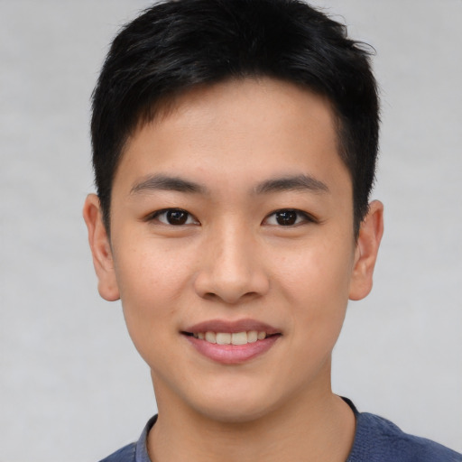 Joyful asian young-adult male with short  brown hair and brown eyes