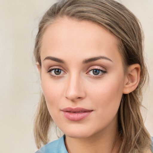 Joyful white young-adult female with long  brown hair and blue eyes