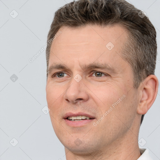 Joyful white adult male with short  brown hair and brown eyes