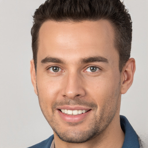 Joyful white young-adult male with short  brown hair and brown eyes