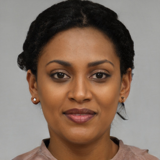 Joyful black young-adult female with short  black hair and brown eyes