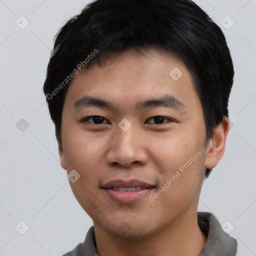 Joyful asian young-adult male with short  black hair and brown eyes