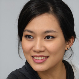 Joyful asian young-adult female with medium  brown hair and brown eyes