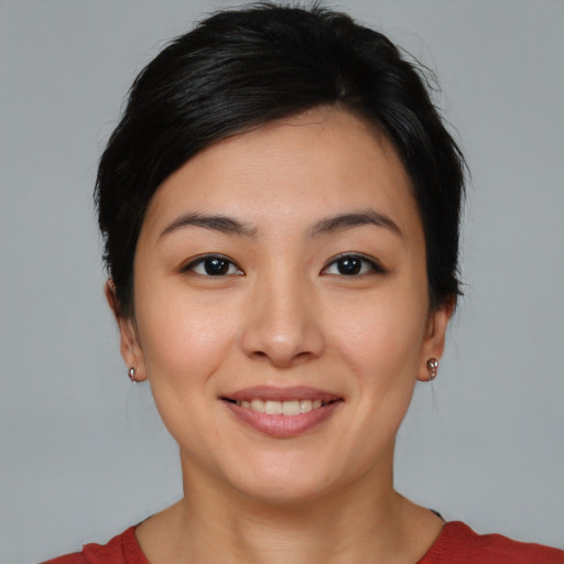 Joyful asian young-adult female with short  brown hair and brown eyes