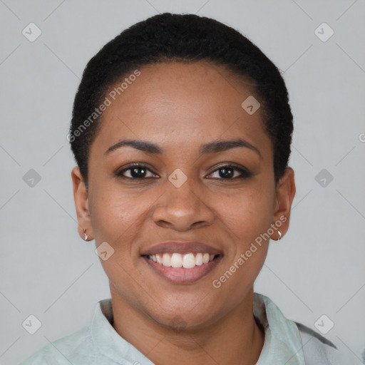 Joyful black young-adult female with short  black hair and brown eyes