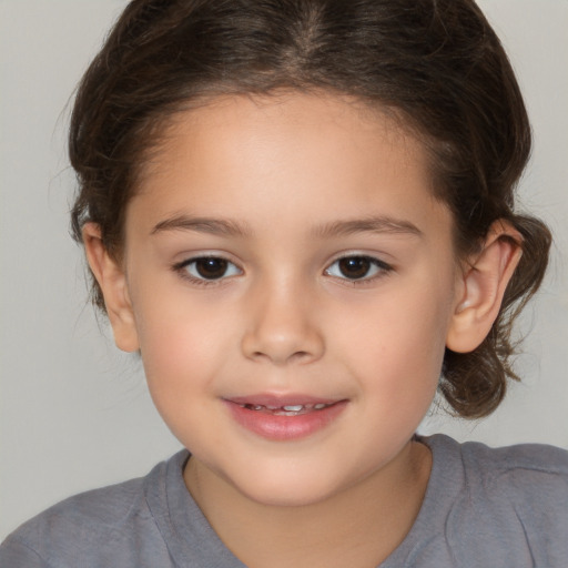 Joyful white child female with medium  brown hair and brown eyes