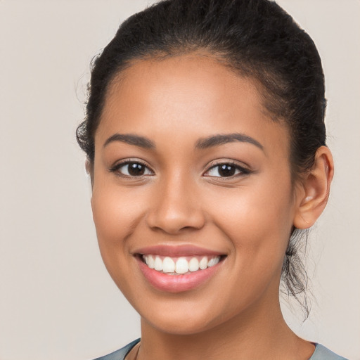 Joyful latino young-adult female with long  brown hair and brown eyes