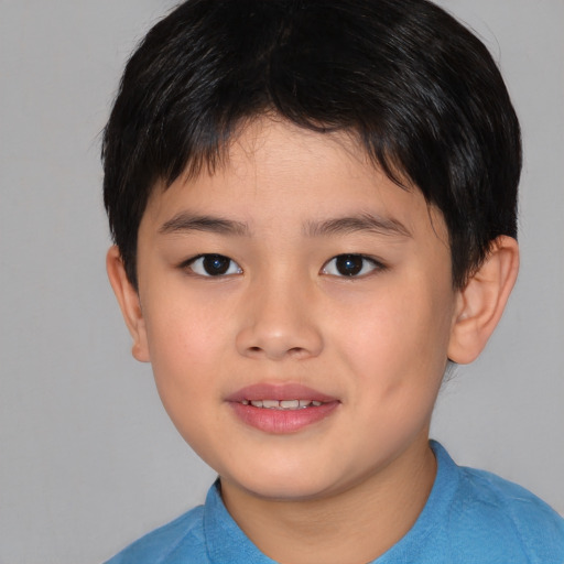 Joyful asian child male with short  brown hair and brown eyes