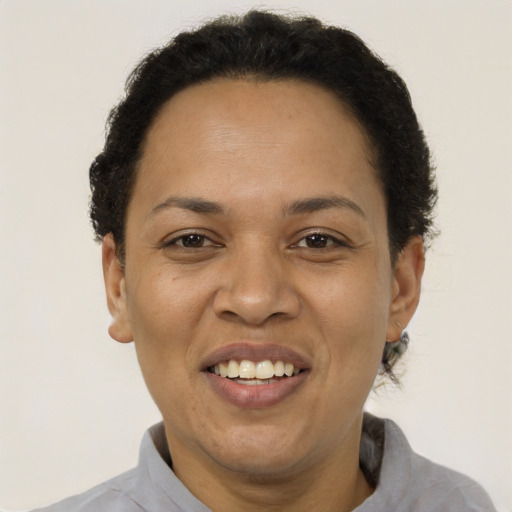 Joyful latino adult female with short  brown hair and brown eyes