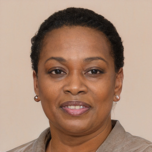 Joyful black adult female with short  brown hair and brown eyes