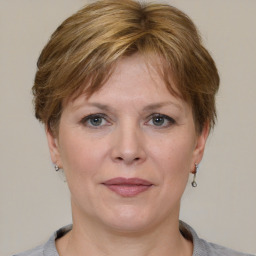 Joyful white adult female with medium  brown hair and grey eyes