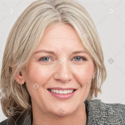 Joyful white adult female with medium  brown hair and blue eyes