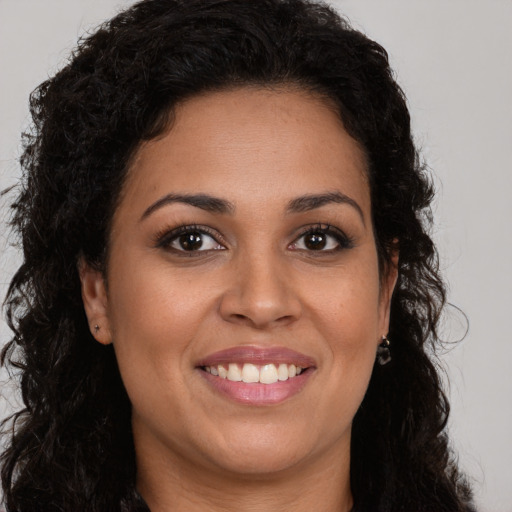 Joyful latino young-adult female with long  brown hair and brown eyes