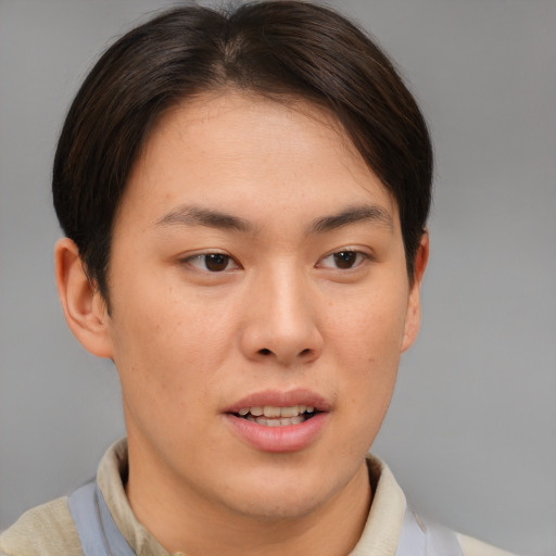 Joyful asian young-adult female with short  brown hair and brown eyes