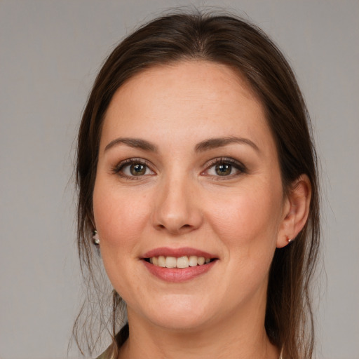 Joyful white young-adult female with medium  brown hair and brown eyes