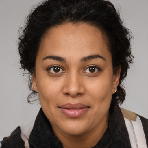 Joyful latino young-adult female with medium  brown hair and brown eyes