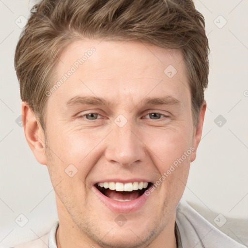 Joyful white adult male with short  brown hair and grey eyes