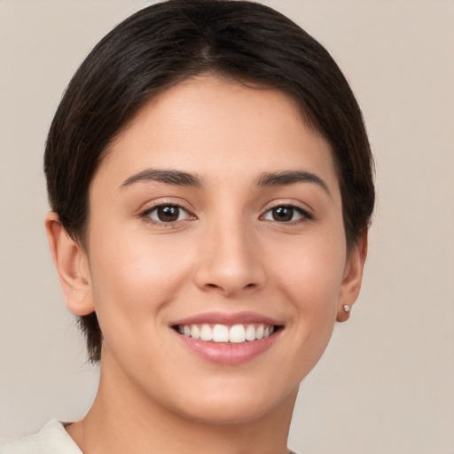 Joyful white young-adult female with short  brown hair and brown eyes