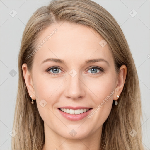 Joyful white young-adult female with long  brown hair and blue eyes