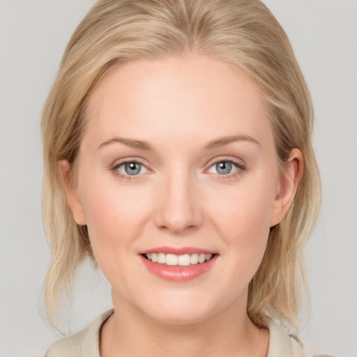 Joyful white young-adult female with medium  blond hair and blue eyes