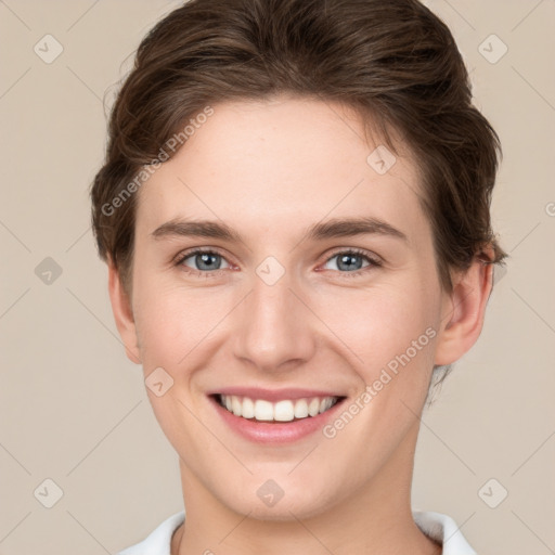 Joyful white young-adult female with short  brown hair and grey eyes