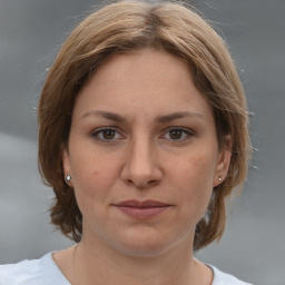 Joyful white adult female with medium  brown hair and brown eyes