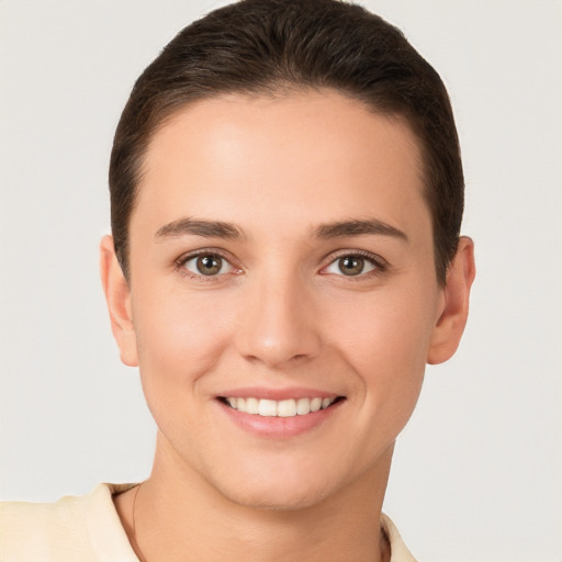 Joyful white young-adult female with short  brown hair and brown eyes