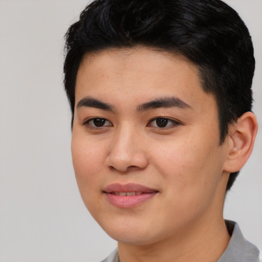 Joyful asian young-adult male with short  black hair and brown eyes