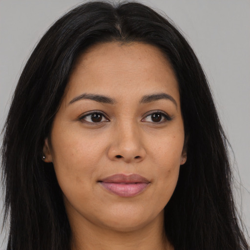 Joyful latino young-adult female with long  brown hair and brown eyes