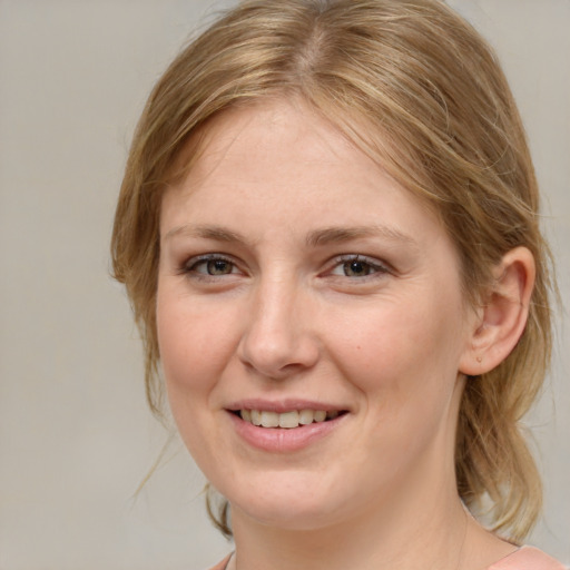 Joyful white young-adult female with medium  brown hair and blue eyes