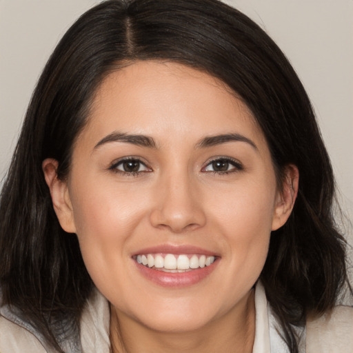 Joyful white young-adult female with medium  brown hair and brown eyes