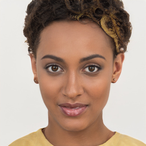 Joyful black young-adult female with short  brown hair and brown eyes