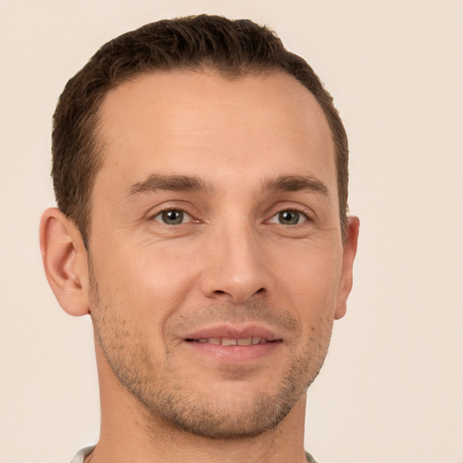 Joyful white young-adult male with short  brown hair and brown eyes