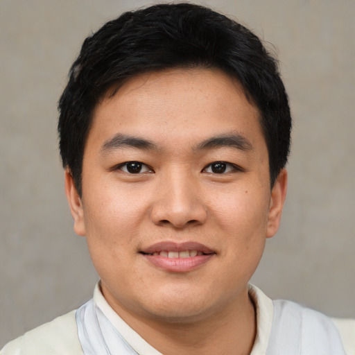 Joyful asian young-adult male with short  black hair and brown eyes