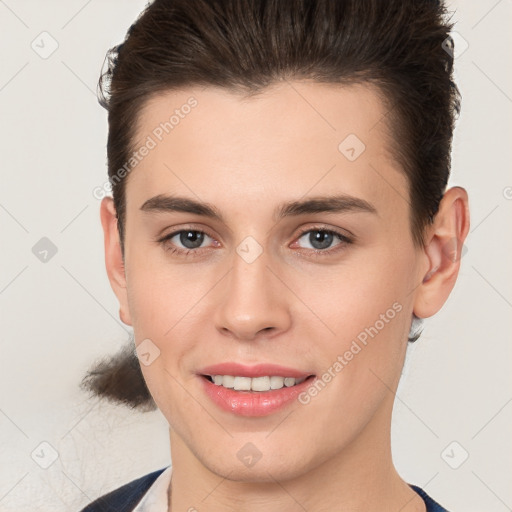 Joyful white young-adult female with short  brown hair and brown eyes