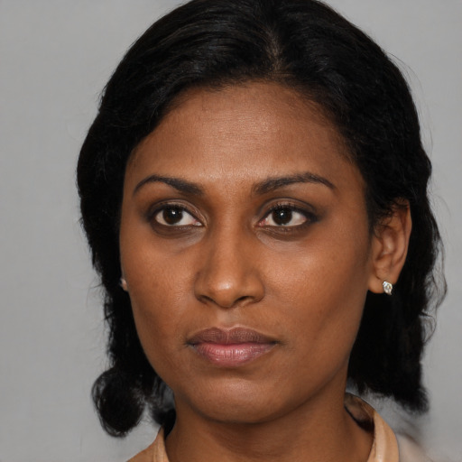 Neutral black young-adult female with medium  black hair and brown eyes