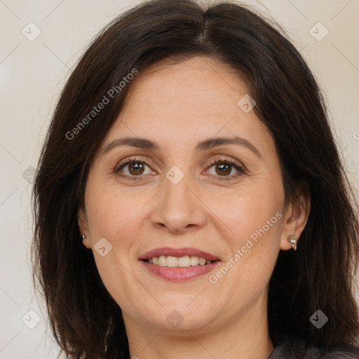 Joyful white adult female with long  brown hair and brown eyes